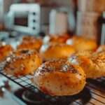 Freshly baked cottage cheese bagels on cooling rack