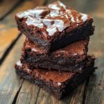 Fudgy flourless brownies stacked with melted chocolate – gluten-free dessert”